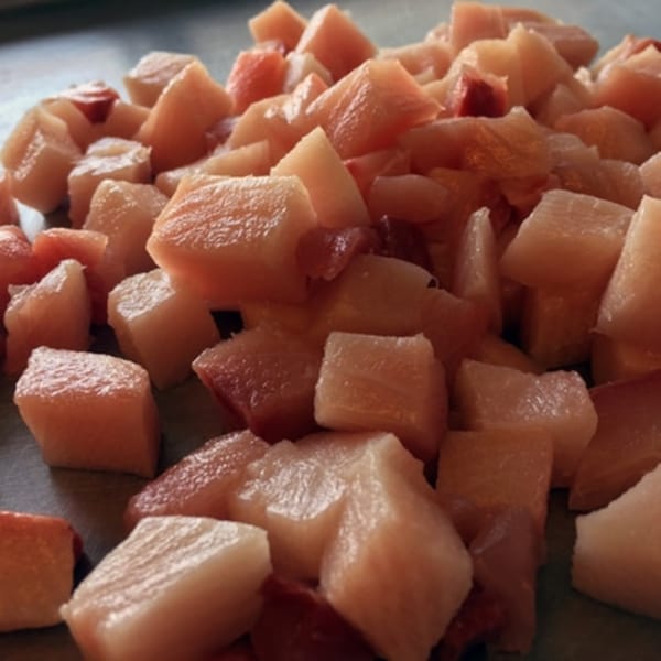 Close-up of fresh, cubed fish pieces, ready for a Poke Poke Fish Bar dish.